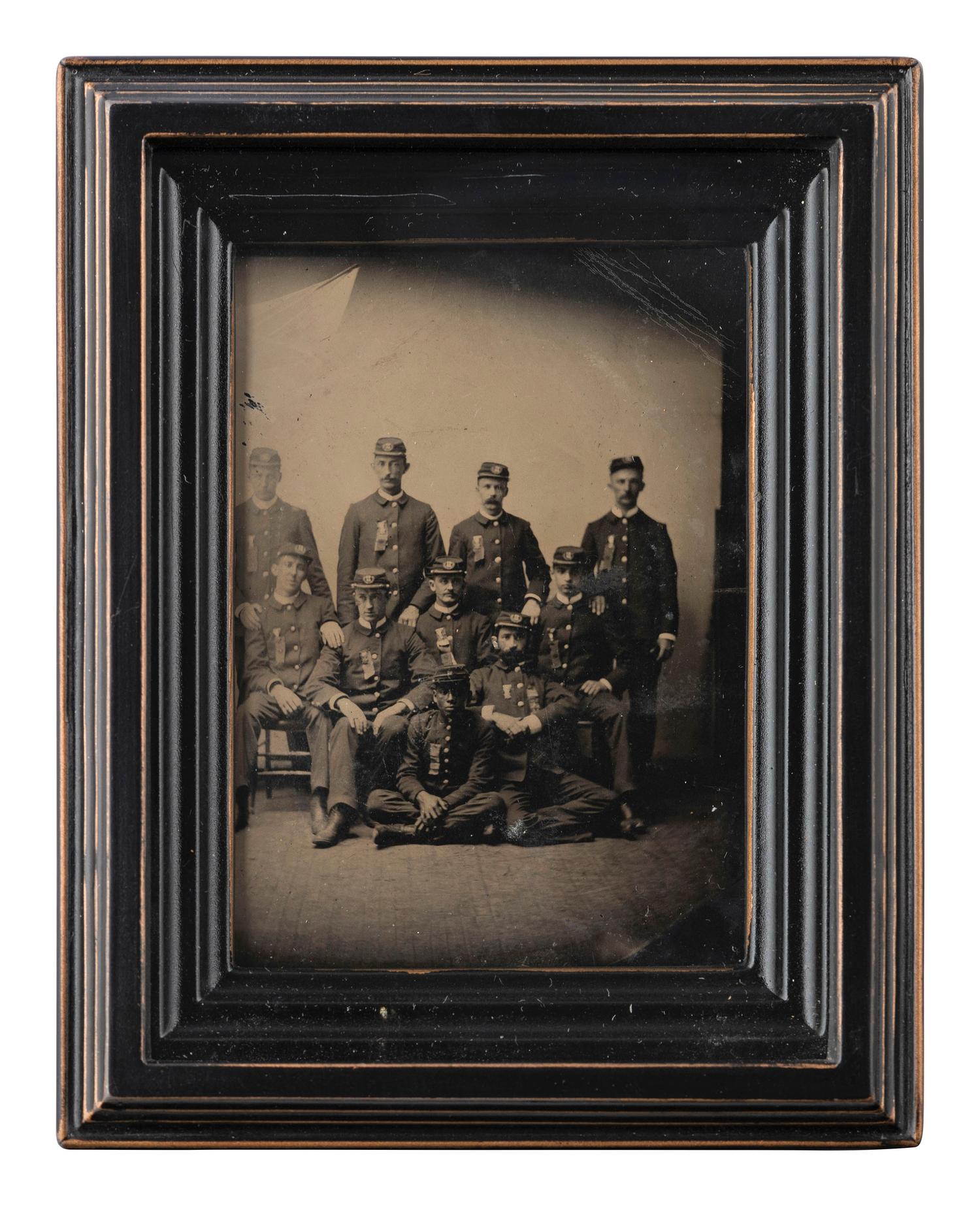 [AFRICAN AMERICANA - EARLY PHOTOGRAPHY]. CDV-sized tintype of a group of men in uniform, incl. African American subject.
