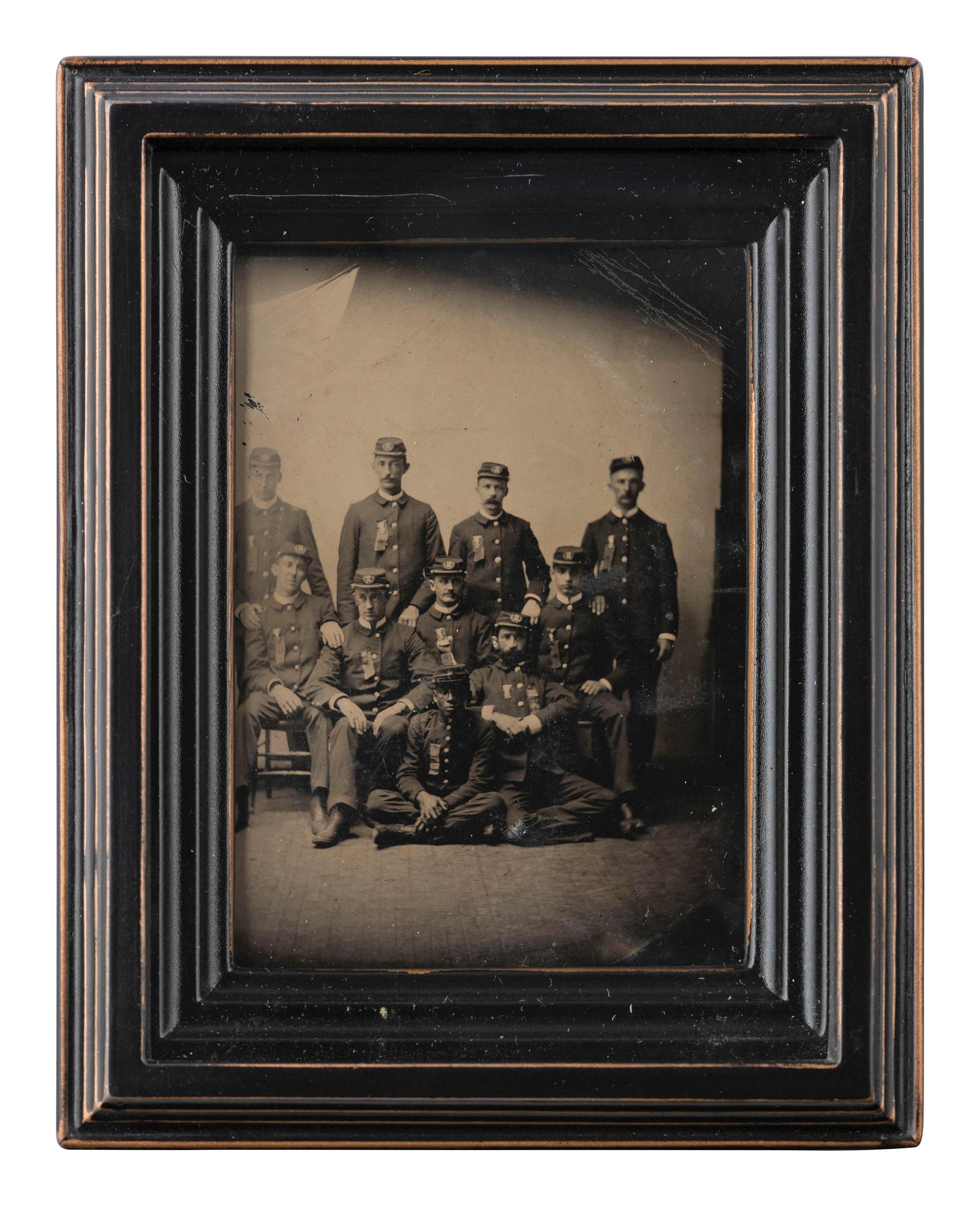 [AFRICAN AMERICANA - EARLY PHOTOGRAPHY]. CDV-sized tintype of a group of men in uniform, incl. African American subject.