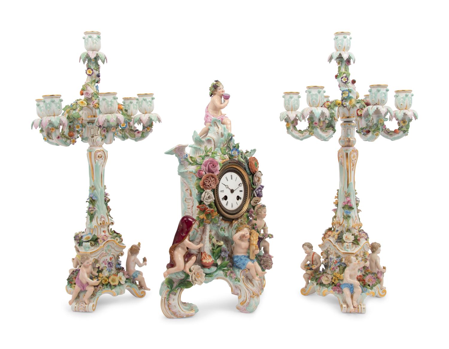 A Meissen Porcelain Clock Garniture and Clock Stand
