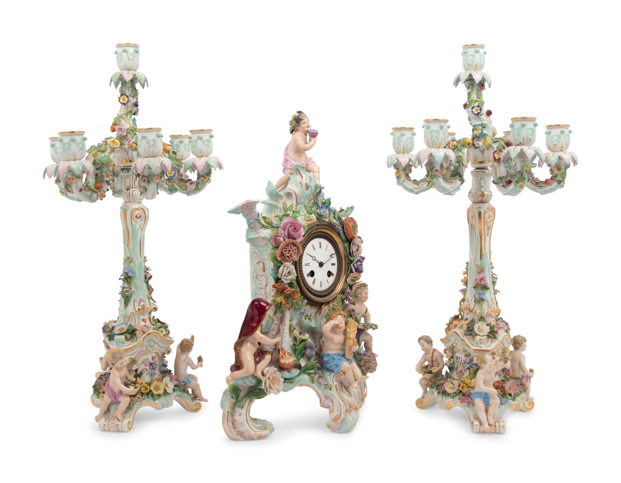 A Meissen Porcelain Clock Garniture and Clock Stand