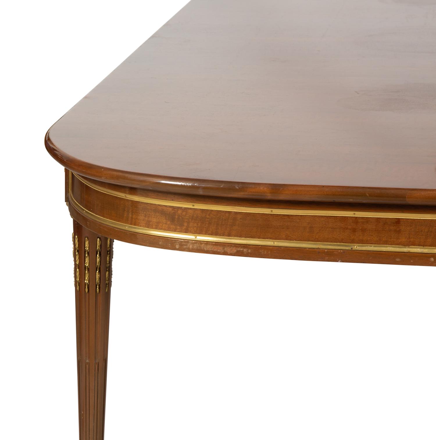 A Louis XVI Style Gilt Bronze Mounted Mahogany Dining Table