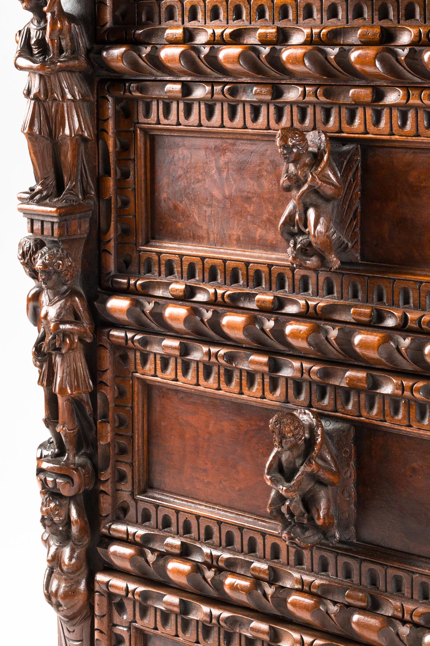 An Italian Renaissance Revival Carved Walnut Chest of Drawers