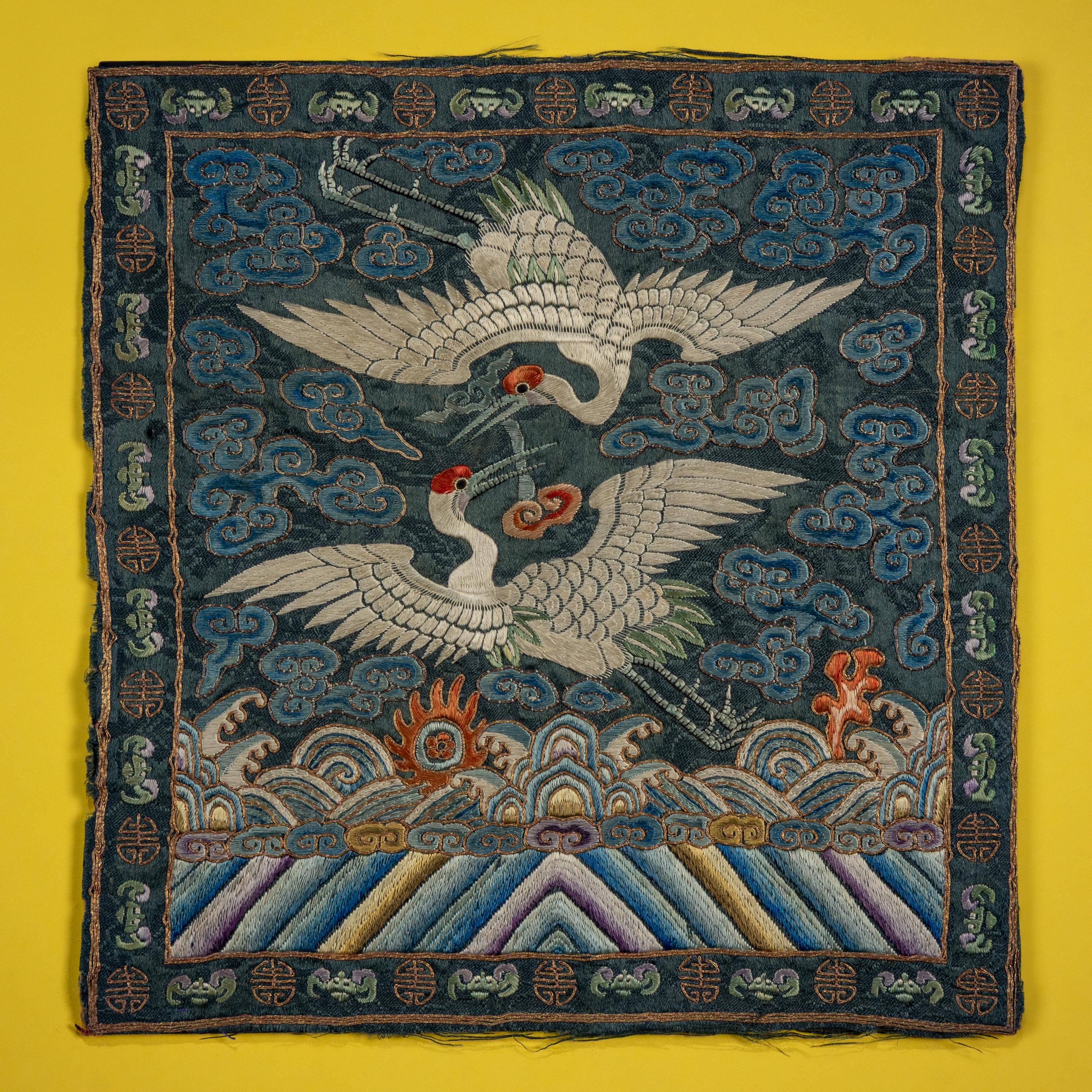 A Pair of Korean Embroidered Silk 'Double Crane' Rank Badges and a Vietnamese Salmon Pink Ground Embroidered Silk 'Crane' Rank Badge, Late 19th Century — 十九世紀晚期 朝鮮王朝文官鶴紋補子一對及越南鶴紋補子