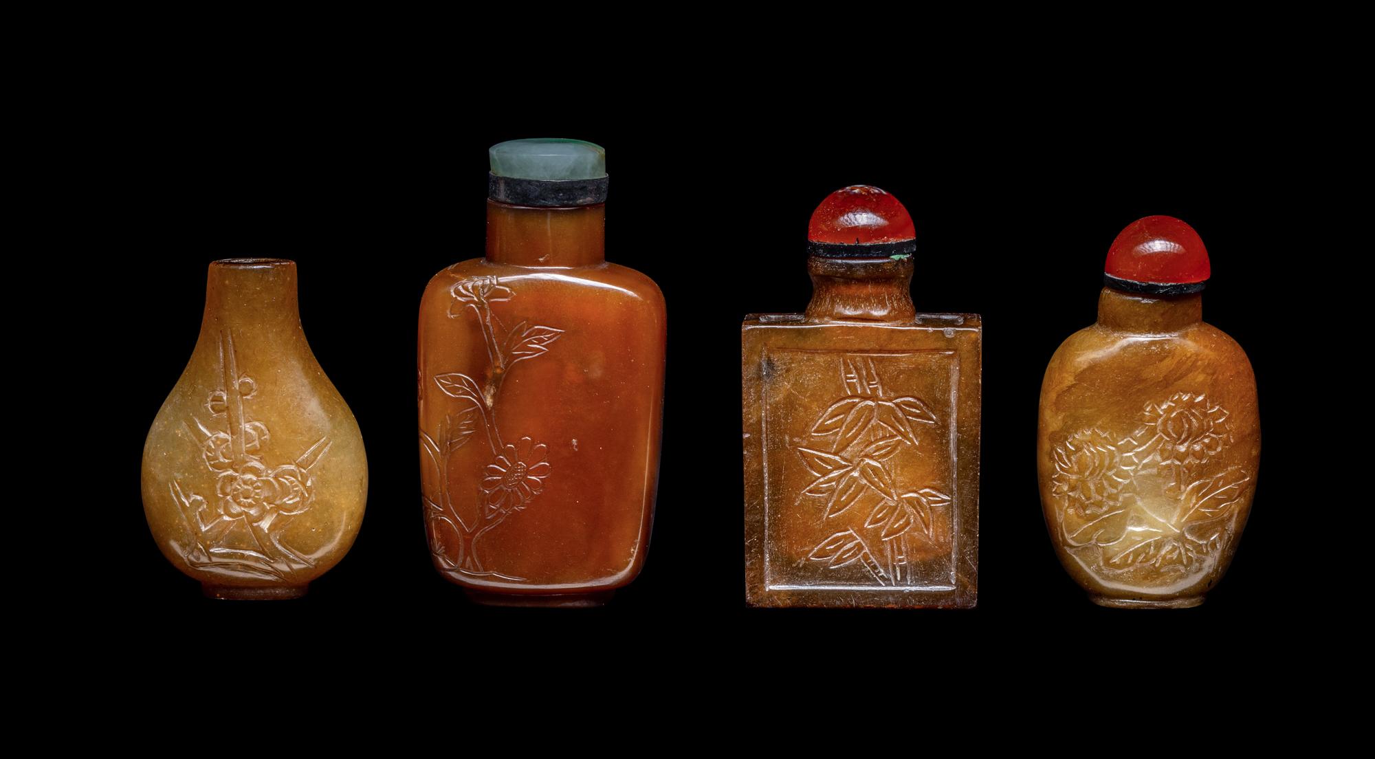 Four Chinese Carved Russet Jade and Hardstone Snuff Bottles