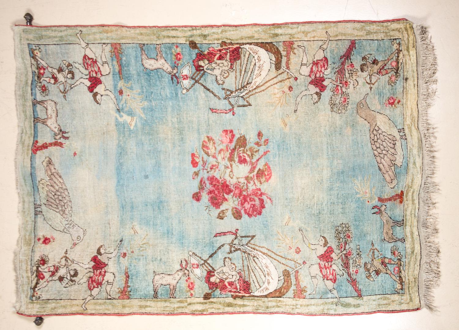A Wool and Silk Pictoral Rug 6 feet 3 3/4 inches x 4 feet 7 inches.