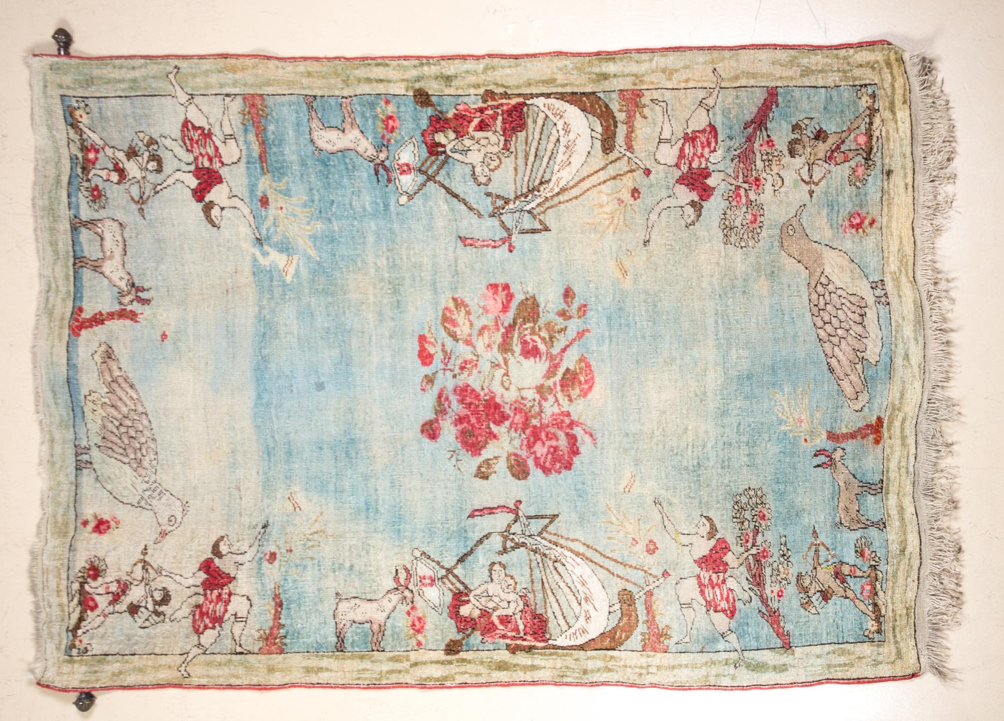 A Wool and Silk Pictoral Rug 6 feet 3 3/4 inches x 4 feet 7 inches.