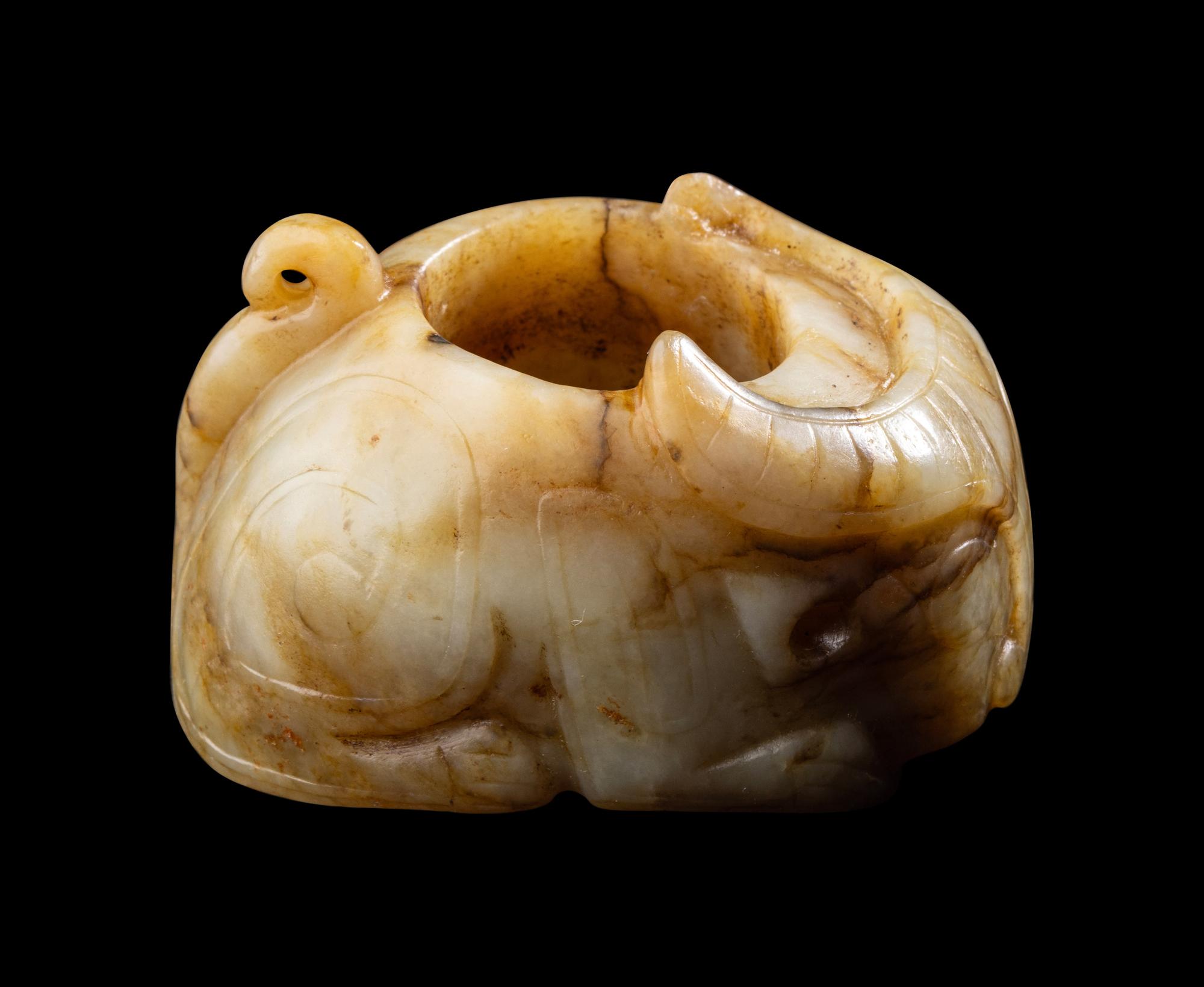 A Chinese Archaistic Yellow Jade Buffalo-Form Archer's Ring
