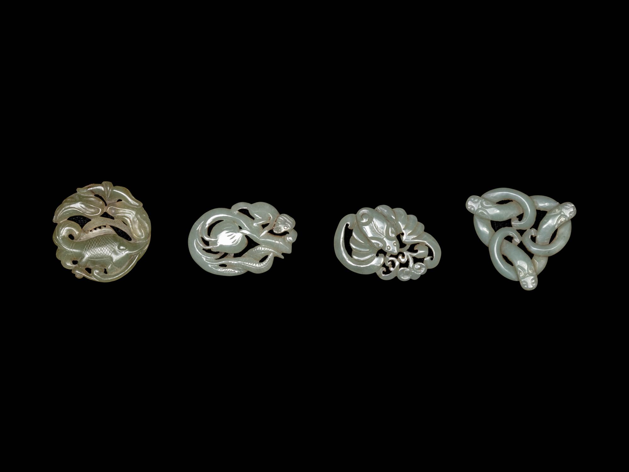 Four Chinese Celadon Jade Carved 'Animal' Pendants