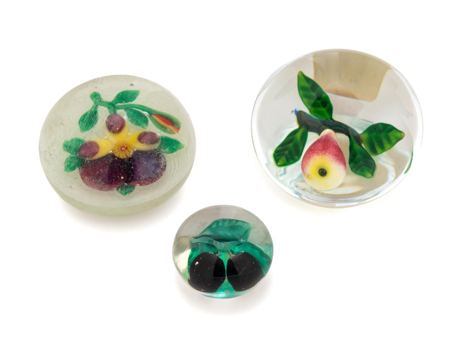 A Two Plums Glass Paperweight, a Chinese Pansy and Bud on Latticino Basket Glass Paperweight and a Pear Glass Paperweight