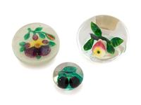 A Two Plums Glass Paperweight, a Chinese Pansy and Bud on Latticino Basket Glass Paperweight and a Pear Glass Paperweight