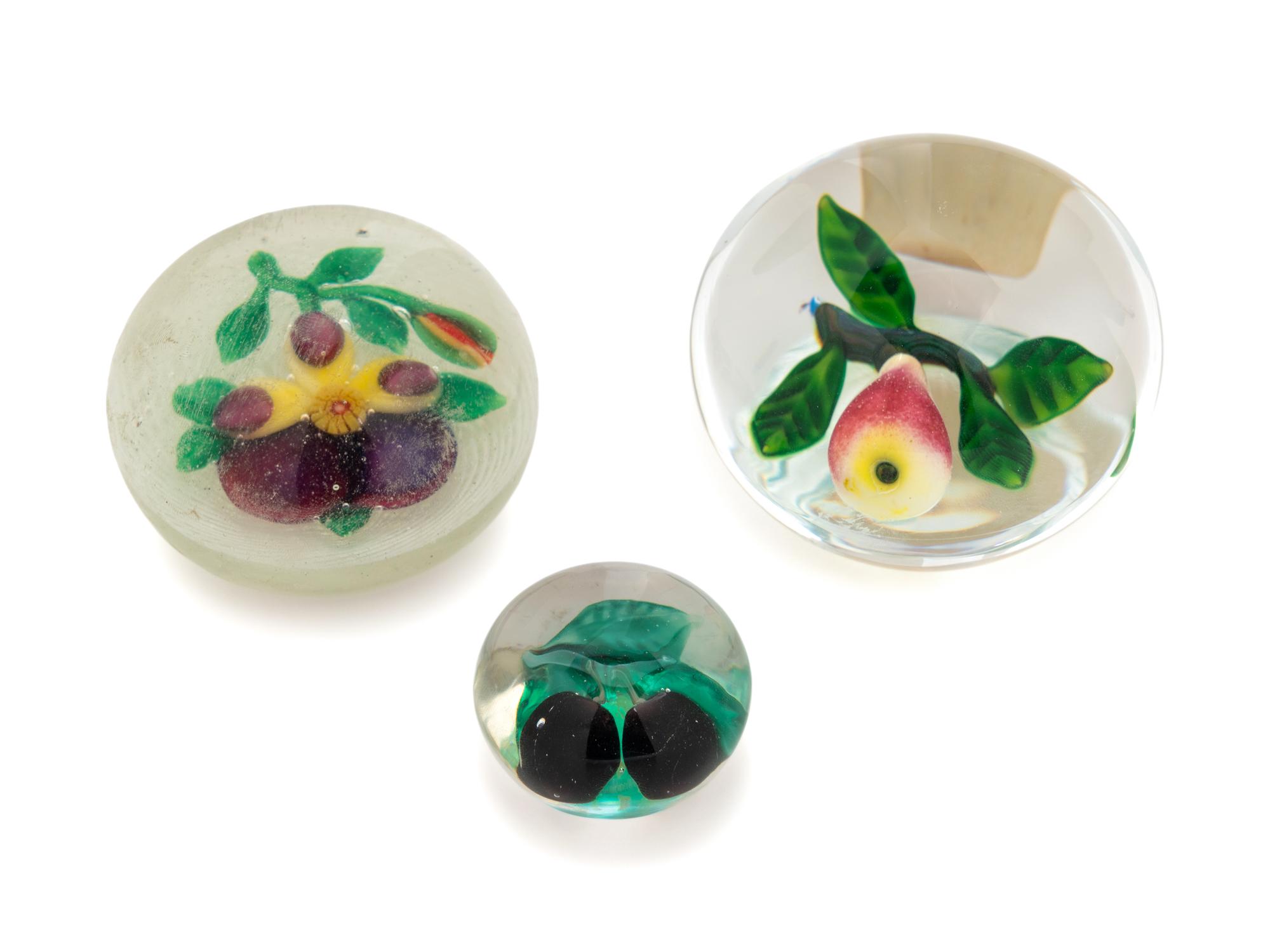 A Two Plums Glass Paperweight, a Chinese Pansy and Bud on Latticino Basket Glass Paperweight and a Pear Glass Paperweight