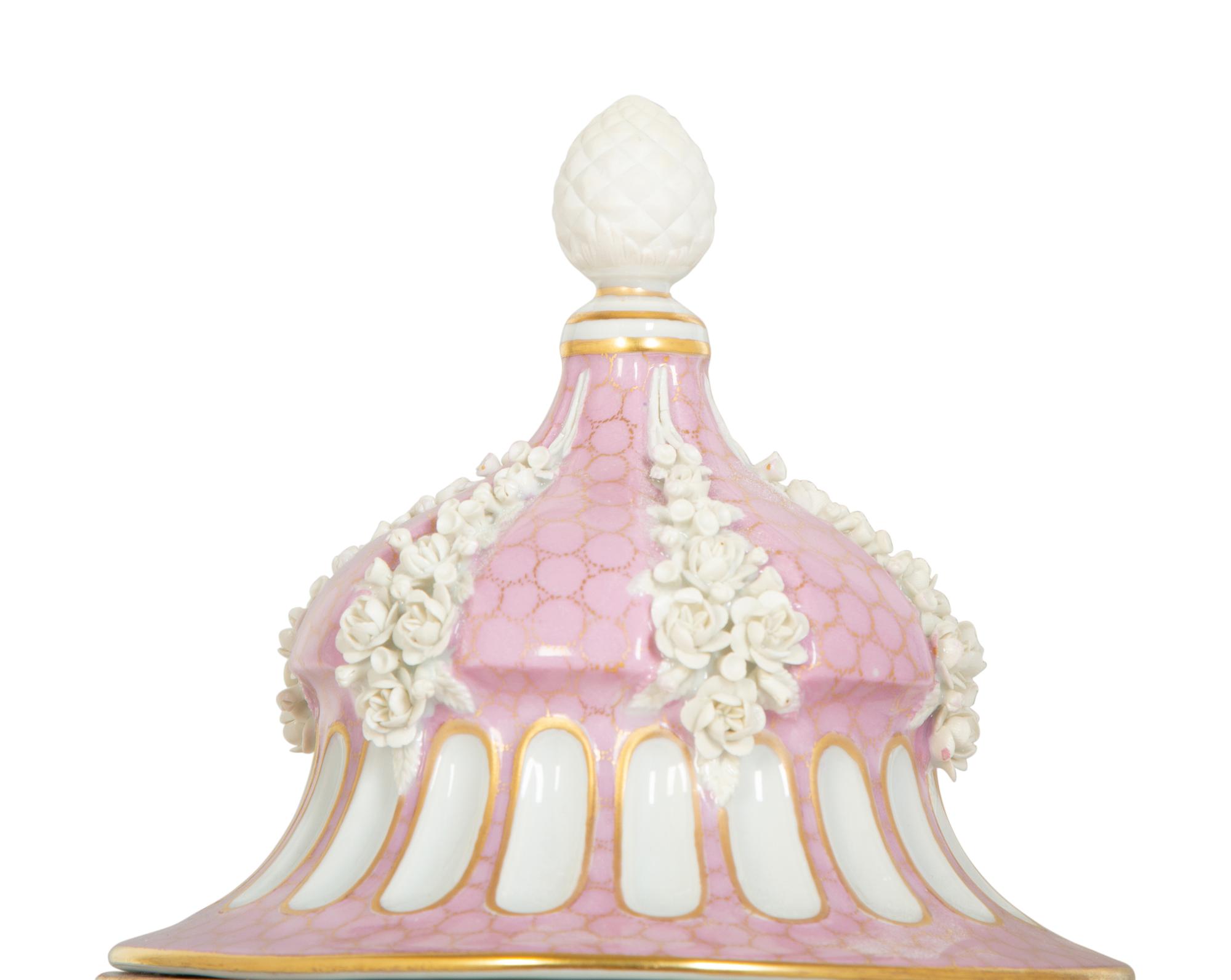 A Sèvres Style Painted Porcelain Lidded Urn with Bisque Floral Swags