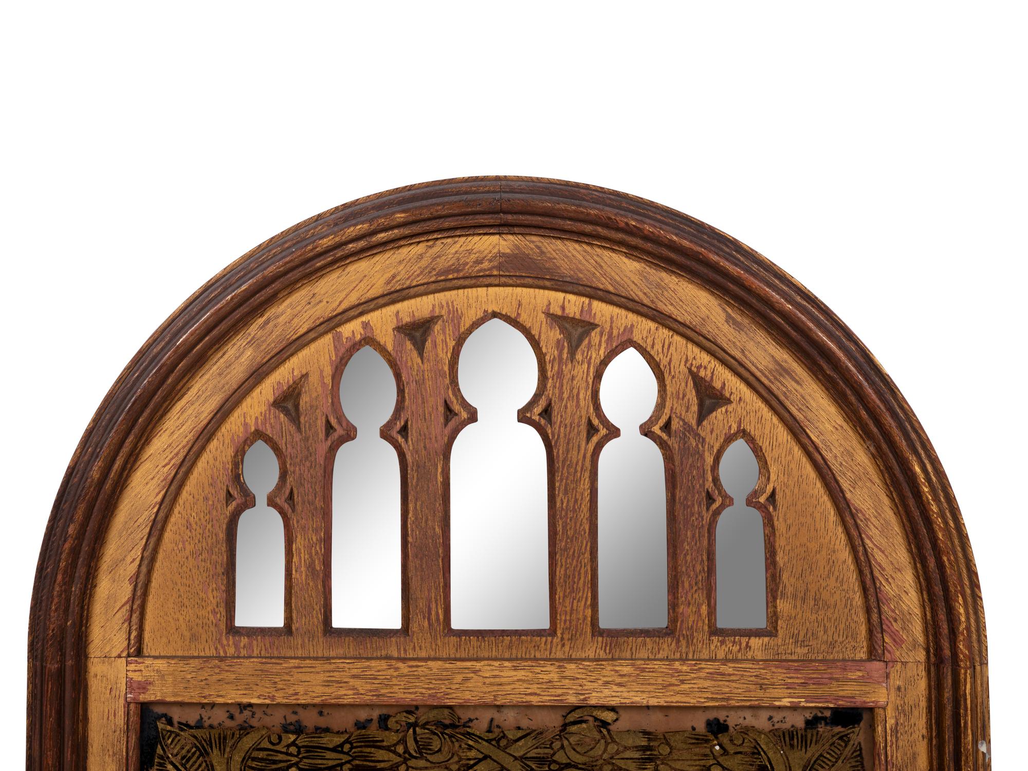 A Gothic Style Giltwood and Églomisé Mirror