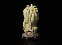 A Chinese carved celadon jade Buddha’s-hand citron with carved wood stand, Qing dynasty 玉雕佛手瓜帶底座 清