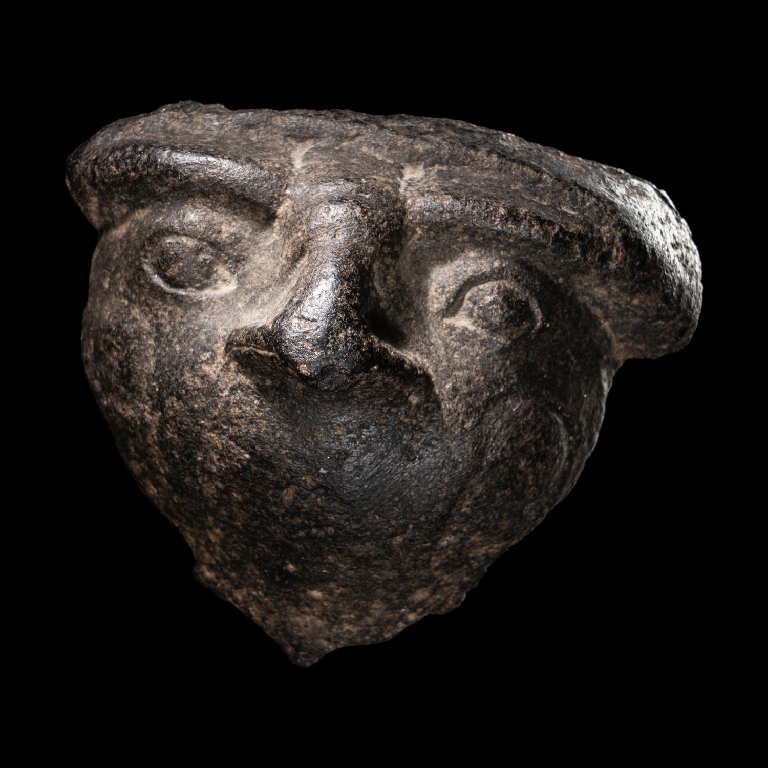 An Egyptian Basalt Falcon Face Fragment
