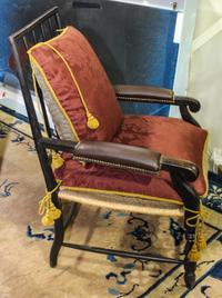 A Wood and Leather Armchair. Height 40 inches.