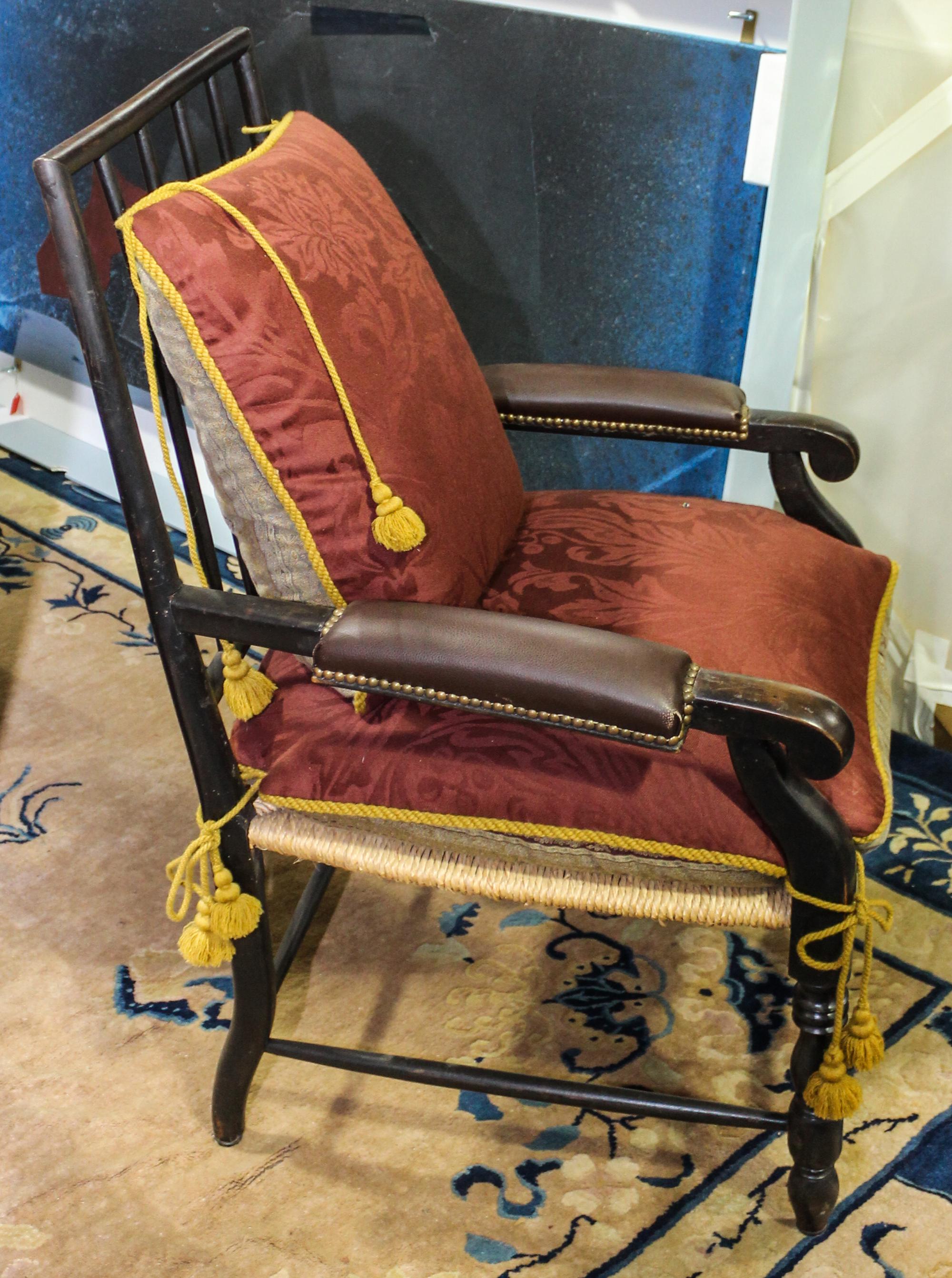 A Wood and Leather Armchair. Height 40 inches.