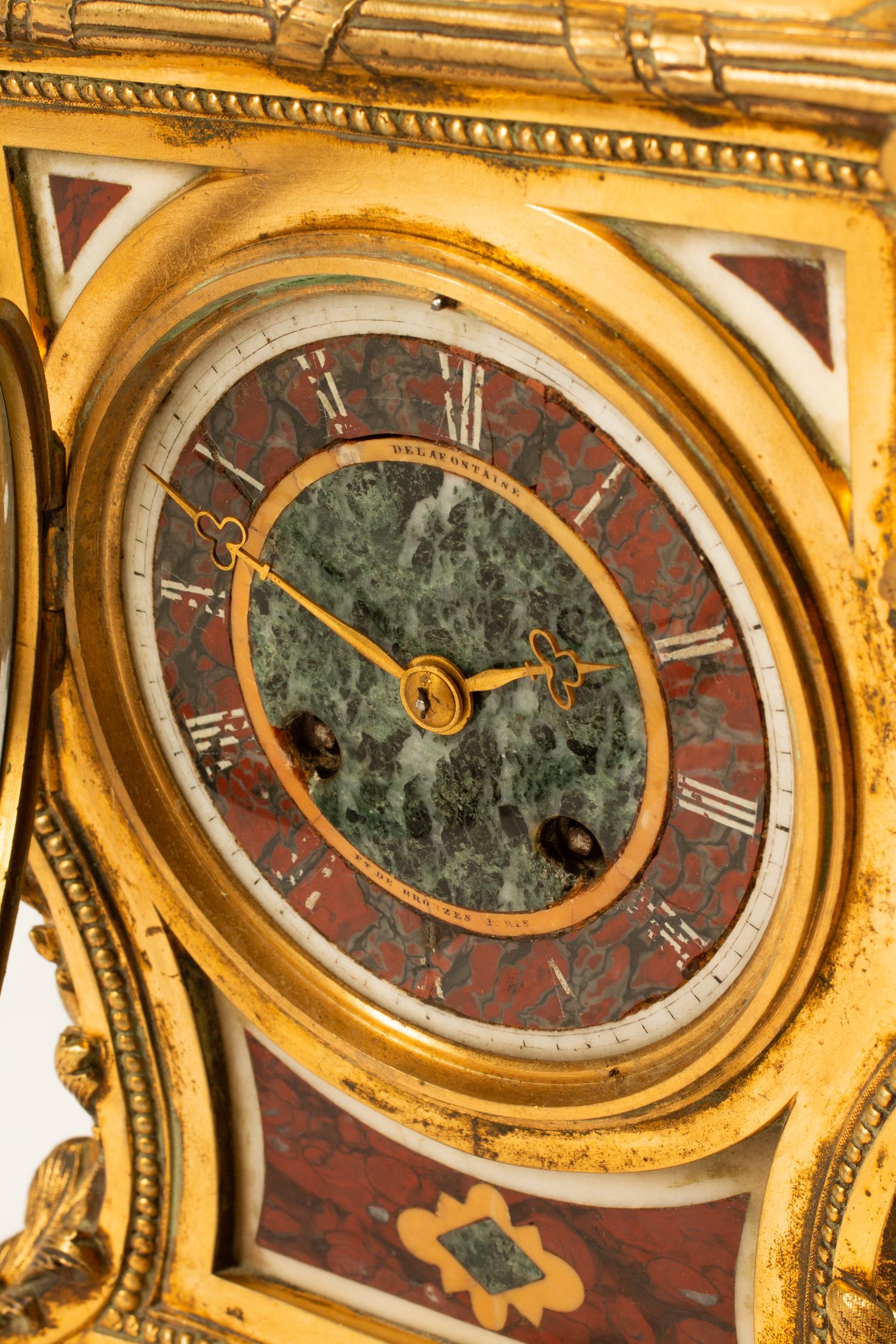 A French Gilt Bronze and Specimen Marble Clock