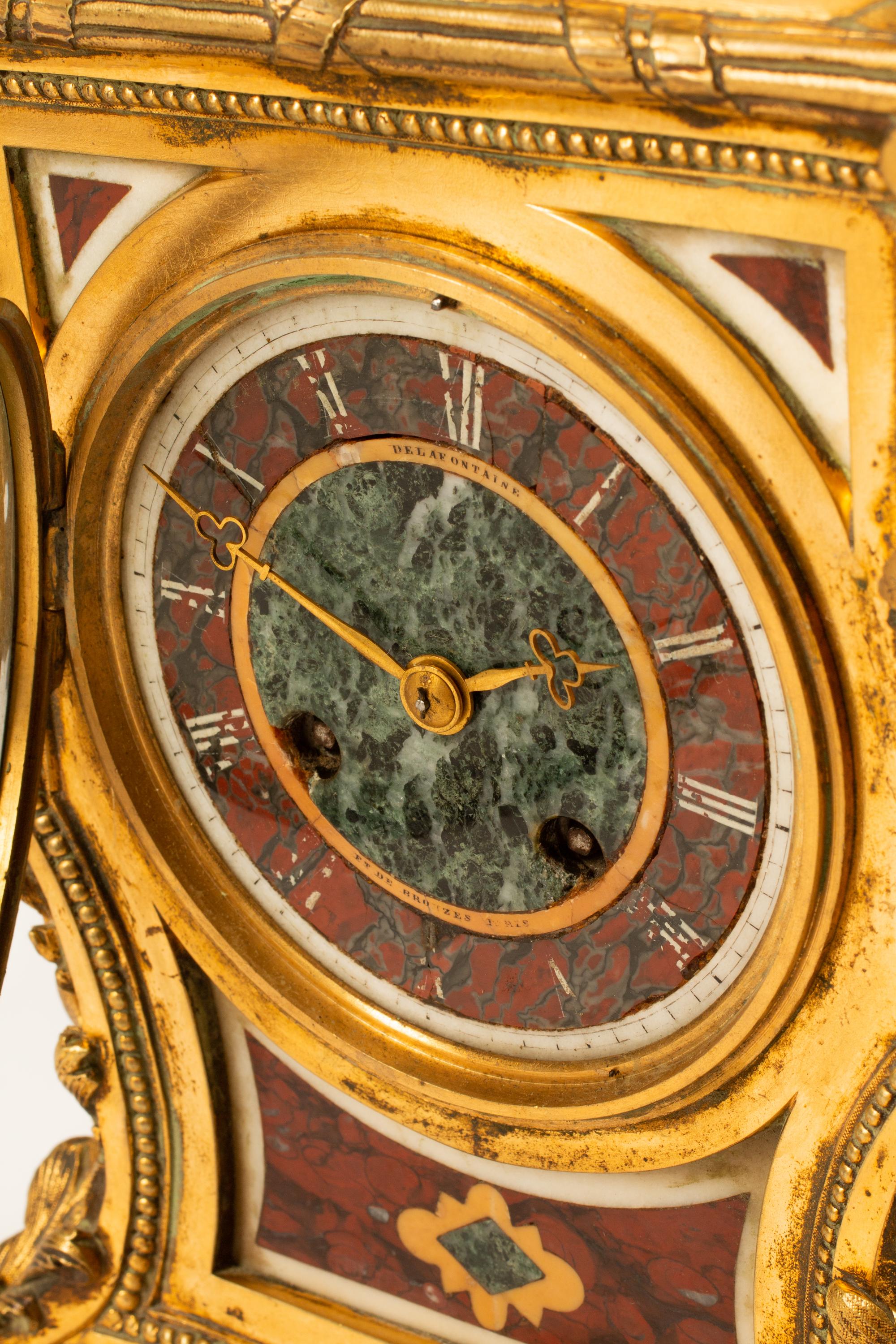 A French Gilt Bronze and Specimen Marble Clock