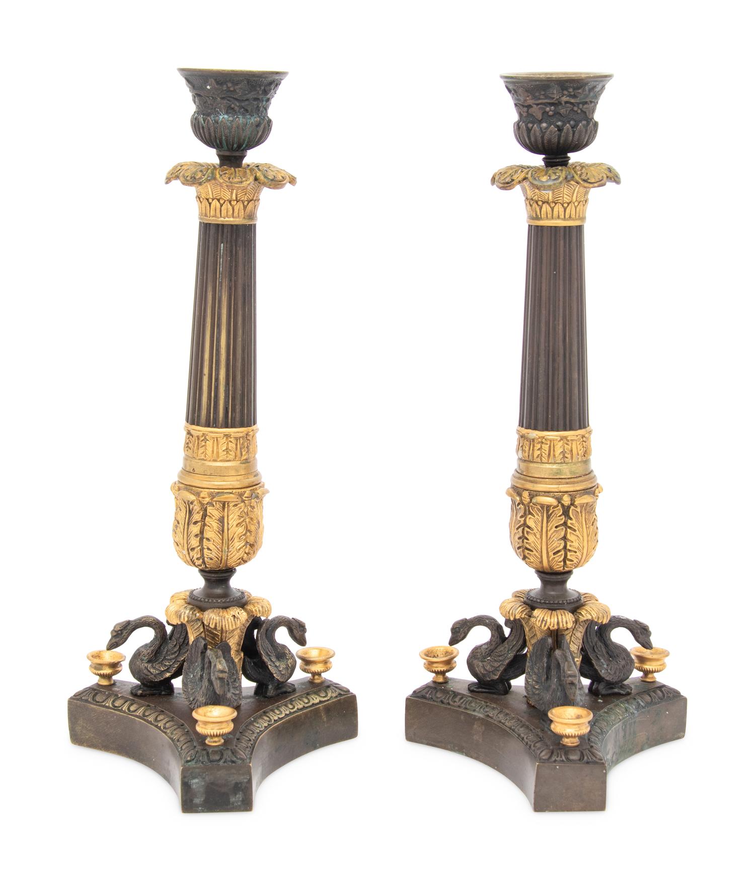 A Pair of French Parcel Gilt and Patinated Bronze Candlesticks