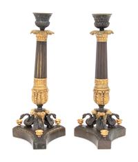 A Pair of French Parcel Gilt and Patinated Bronze Candlesticks
