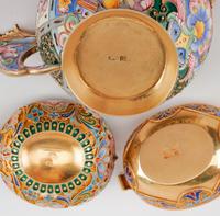 Three Russian Enameled Silver Kovshi, Various Makers, Late 19th/Early 20th Century, each having an exterior decorated with polychrome f