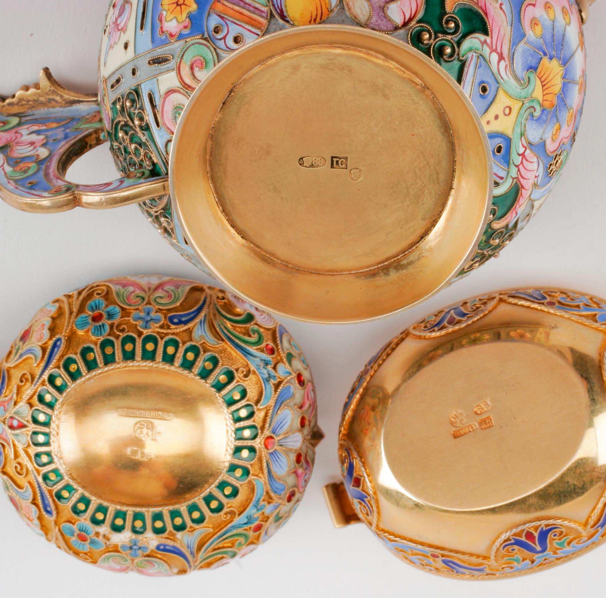 Three Russian Enameled Silver Kovshi, Various Makers, Late 19th/Early 20th Century, each having an exterior decorated with polychrome f