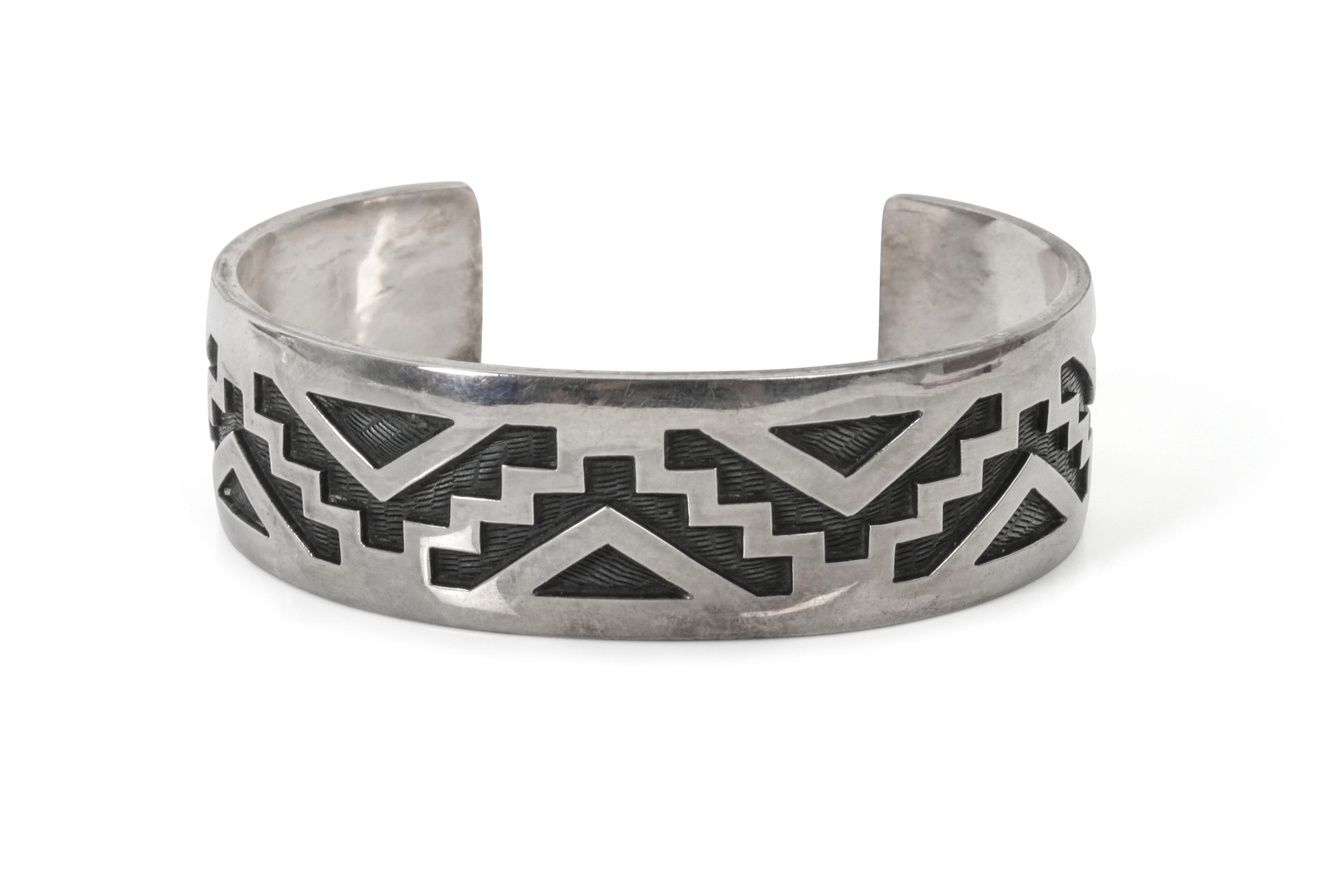 A Hopi Silver Overlay Bracelet, Bradley Gashwazra Length 6 3/8 x opening 1 1/4 x width 3/4 inches.
