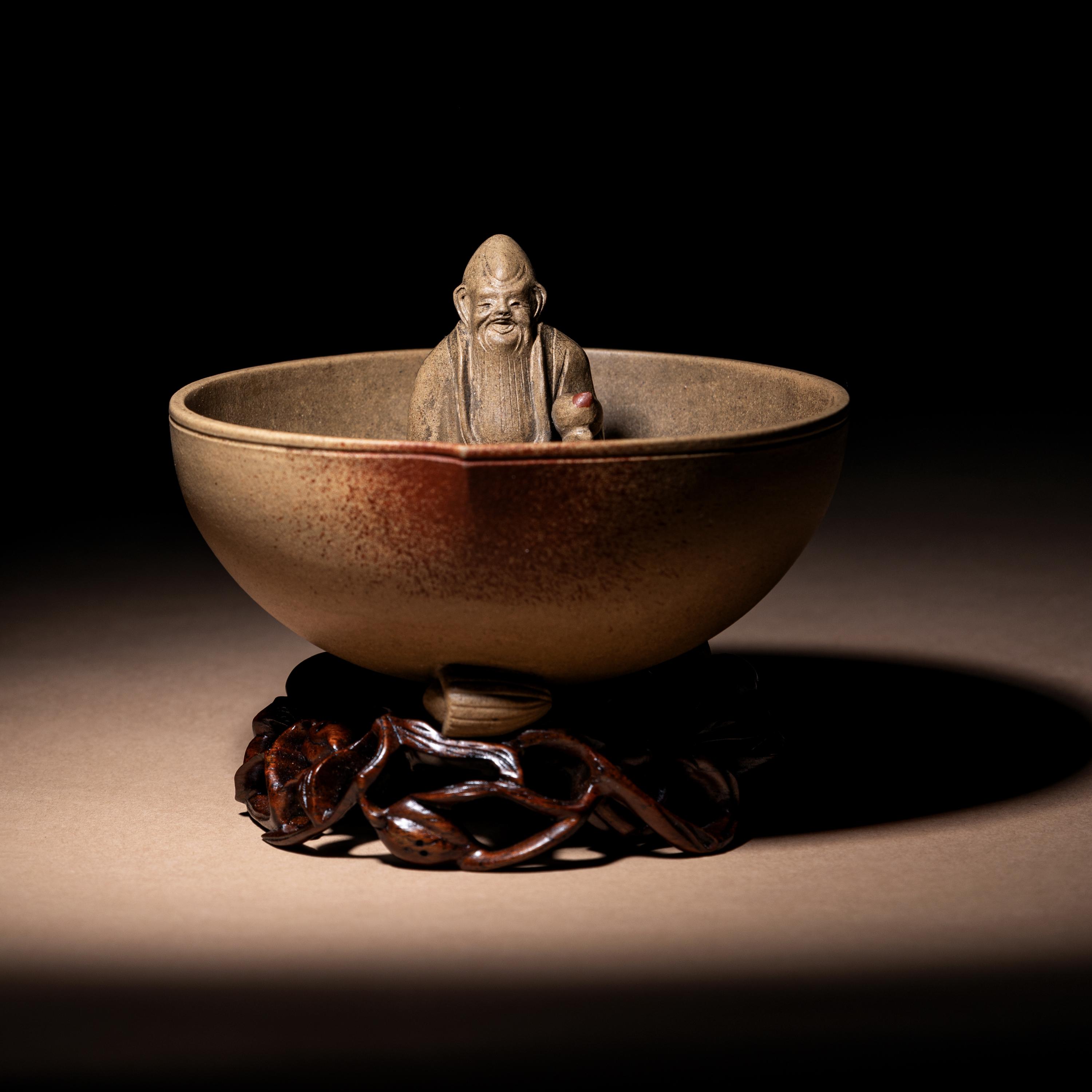 A Rare Yixing Peach-Form 'Figure' Puzzle Cup with Impressed Seals 'Chen', 'Mingyuan' and Wood Stand 陳鳴遠款醉翁桃形公道杯