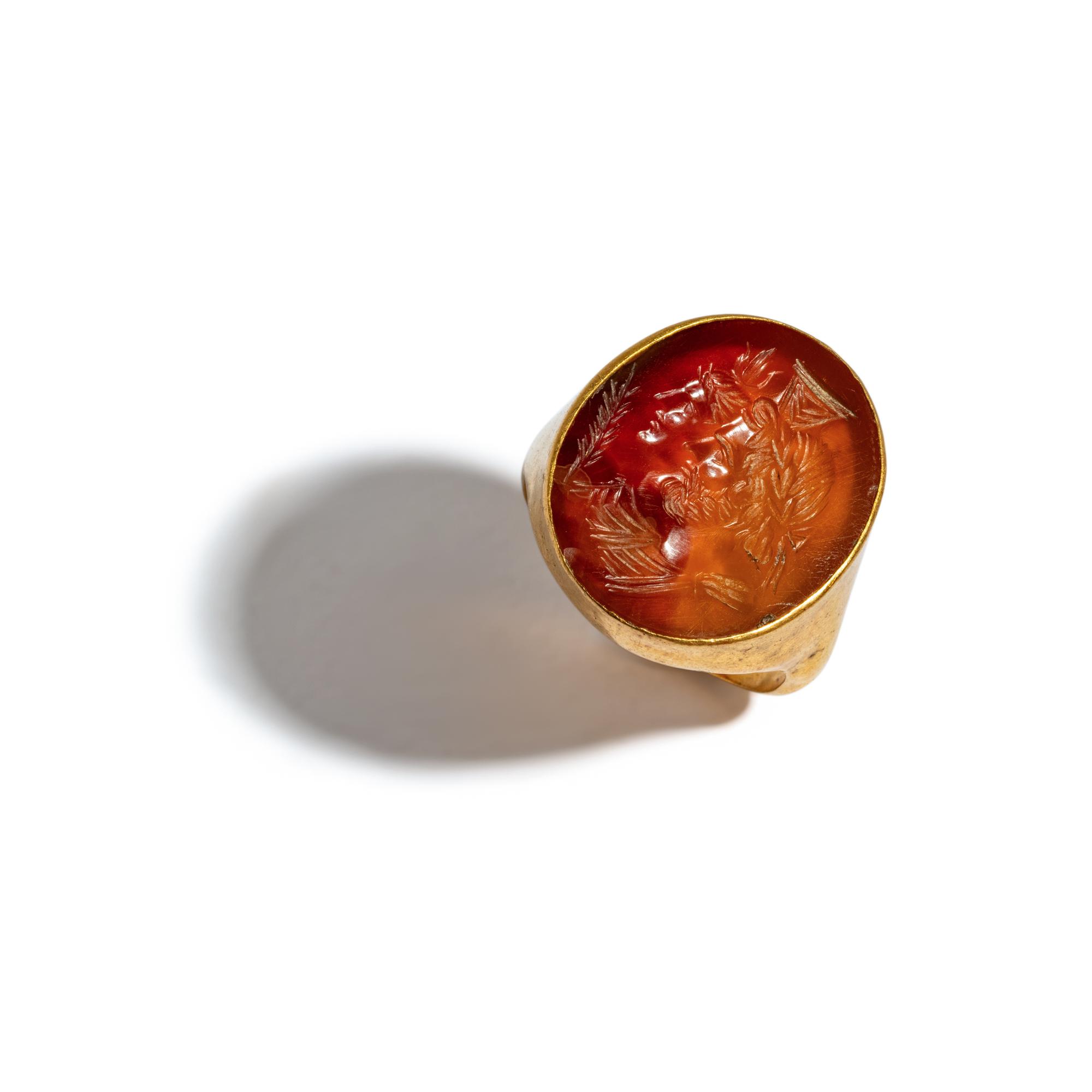 A Neoclassical Gold and Carnelian Finger Ring with the Gods Serapis and Isis