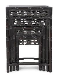 A Set of Four Chinese Ebonized Carved Teak Nesting Tables
