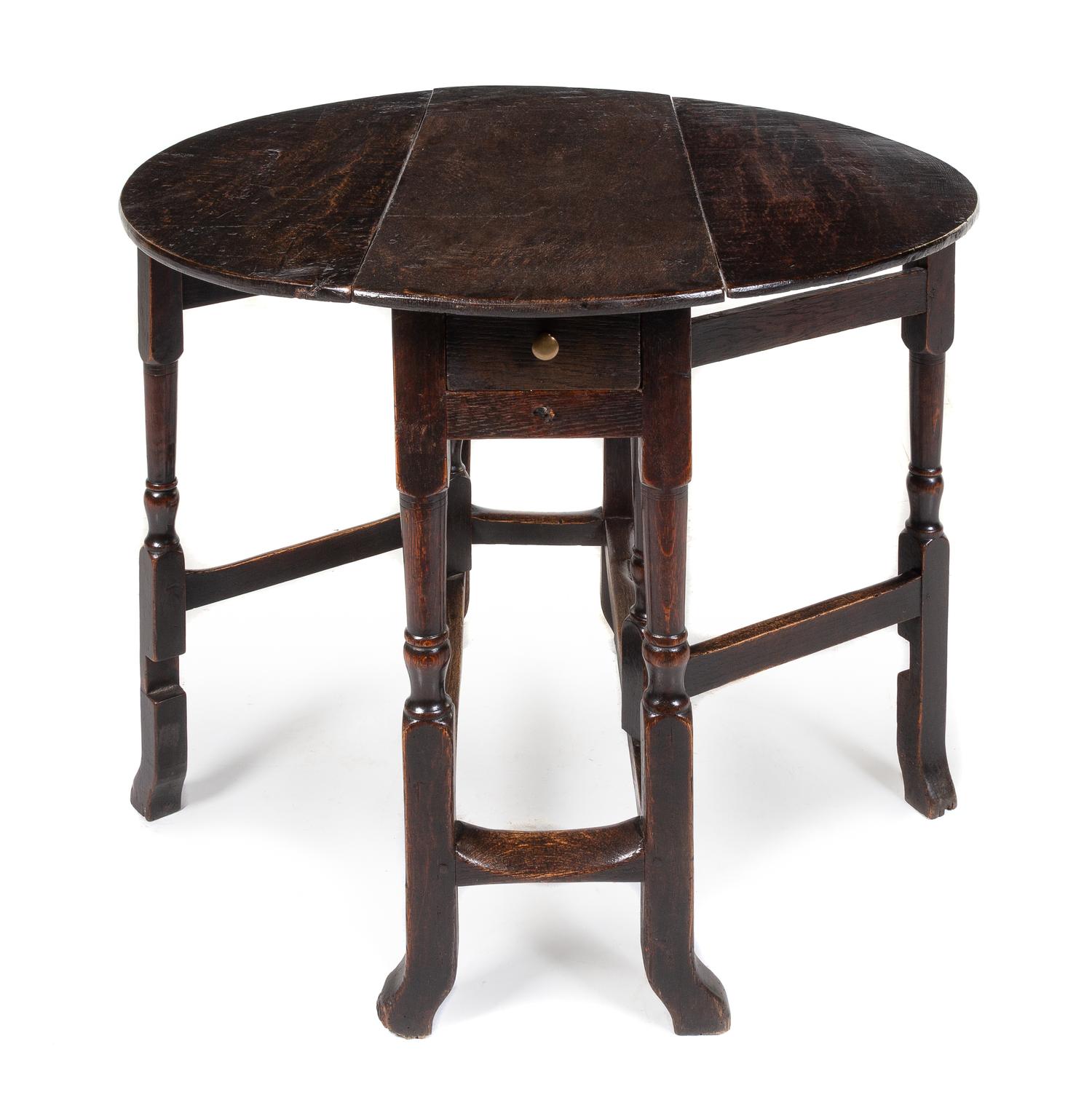 A William and Mary Oak Drop-Leaf Table Height 28 x width 34 x depth 12 1/2 inches. — CIRCA 1680
