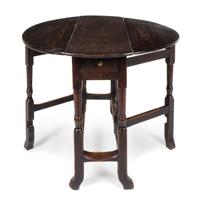 A William and Mary Oak Drop-Leaf Table Height 28 x width 34 x depth 12 1/2 inches. — CIRCA 1680