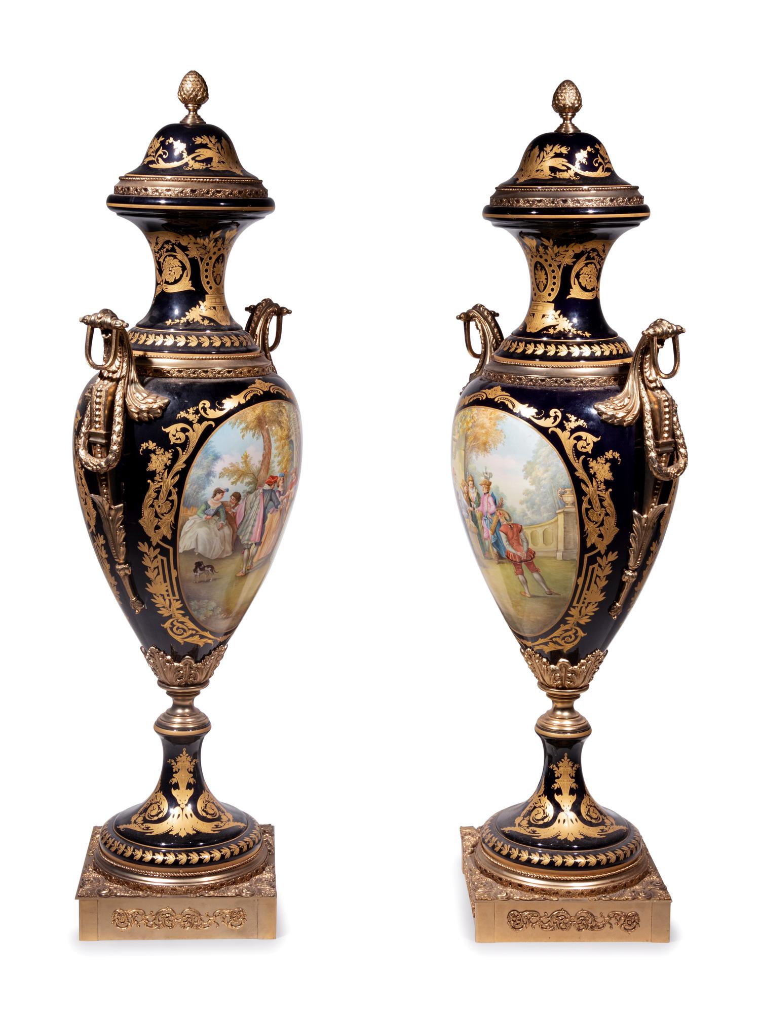 A Pair of Monumental Sèvres Style Gilt Metal Mounted Porcelain Covered Urns on Pedestals