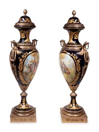 A Pair of Monumental Sèvres Style Gilt Metal Mounted Porcelain Covered Urns on Pedestals