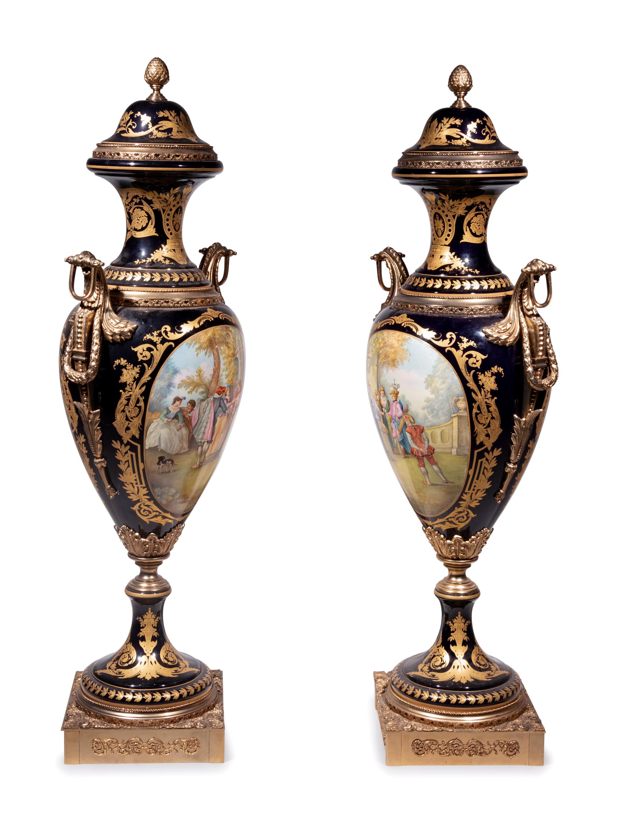 A Pair of Monumental Sèvres Style Gilt Metal Mounted Porcelain Covered Urns on Pedestals