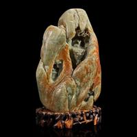 A Large Chinese carved celadon and russet jade mountain and wood stand