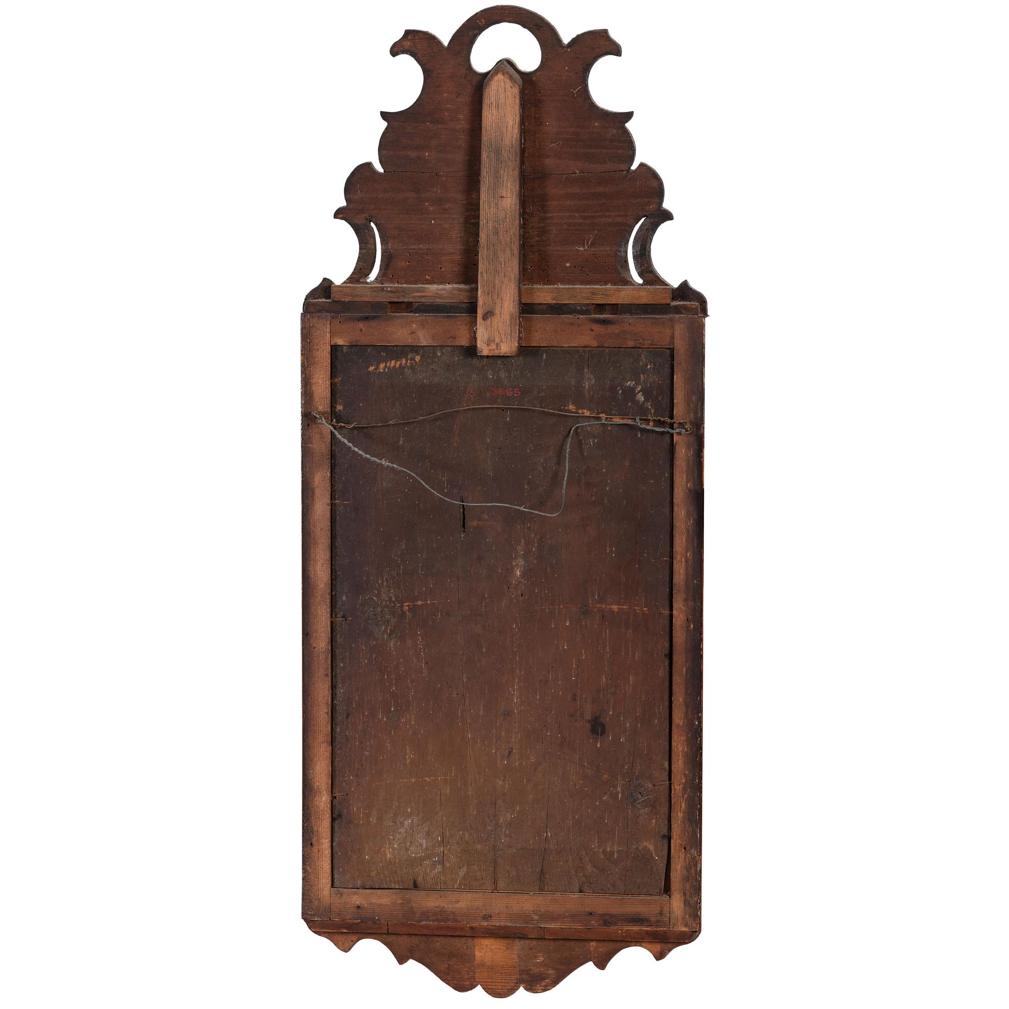 A Queen Anne Parcel Gilt and Carved Walnut Looking Glass