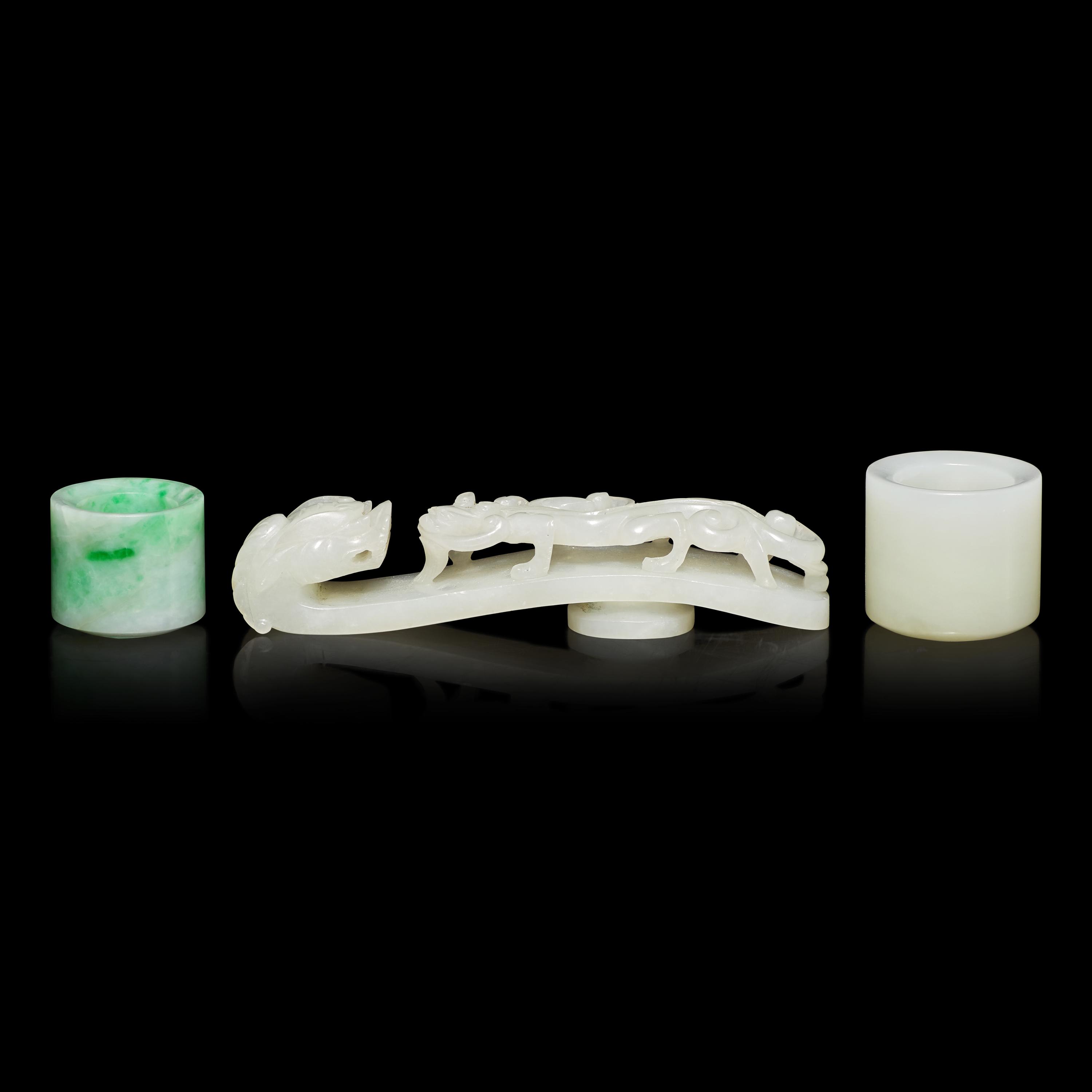 Two Chinese Jade and Jadeite Archer's Rings and a Jade 'Dragon' Belt Hook, Qing Dynasty 清 白玉、翡翠扳指及龍鈎一組三件