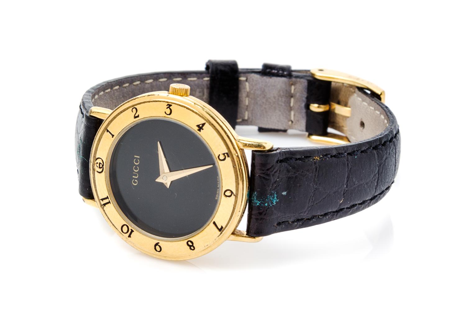 A Gucci Goldtone Wristwatch, 7" x 1".
