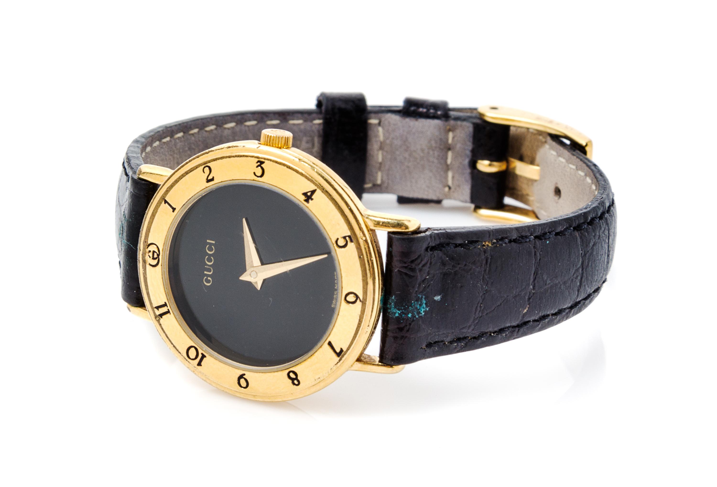 A Gucci Goldtone Wristwatch, 7" x 1".