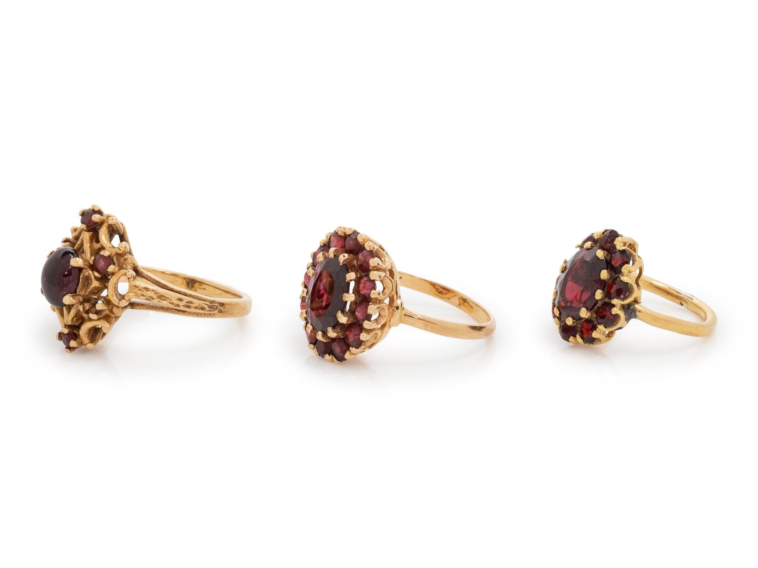 A Collection of Yellow Gold and Garnet Rings,