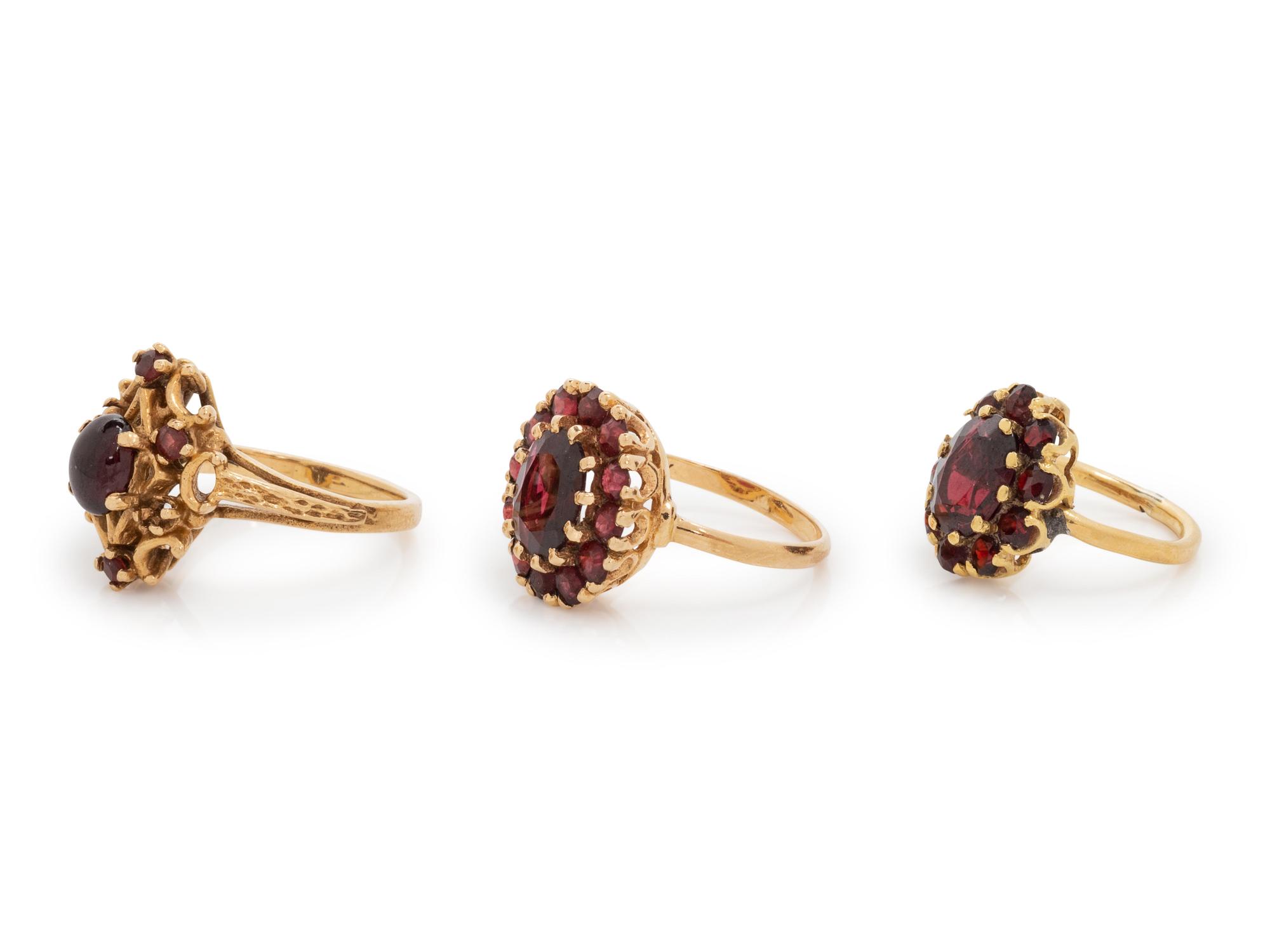 A Collection of Yellow Gold and Garnet Rings,