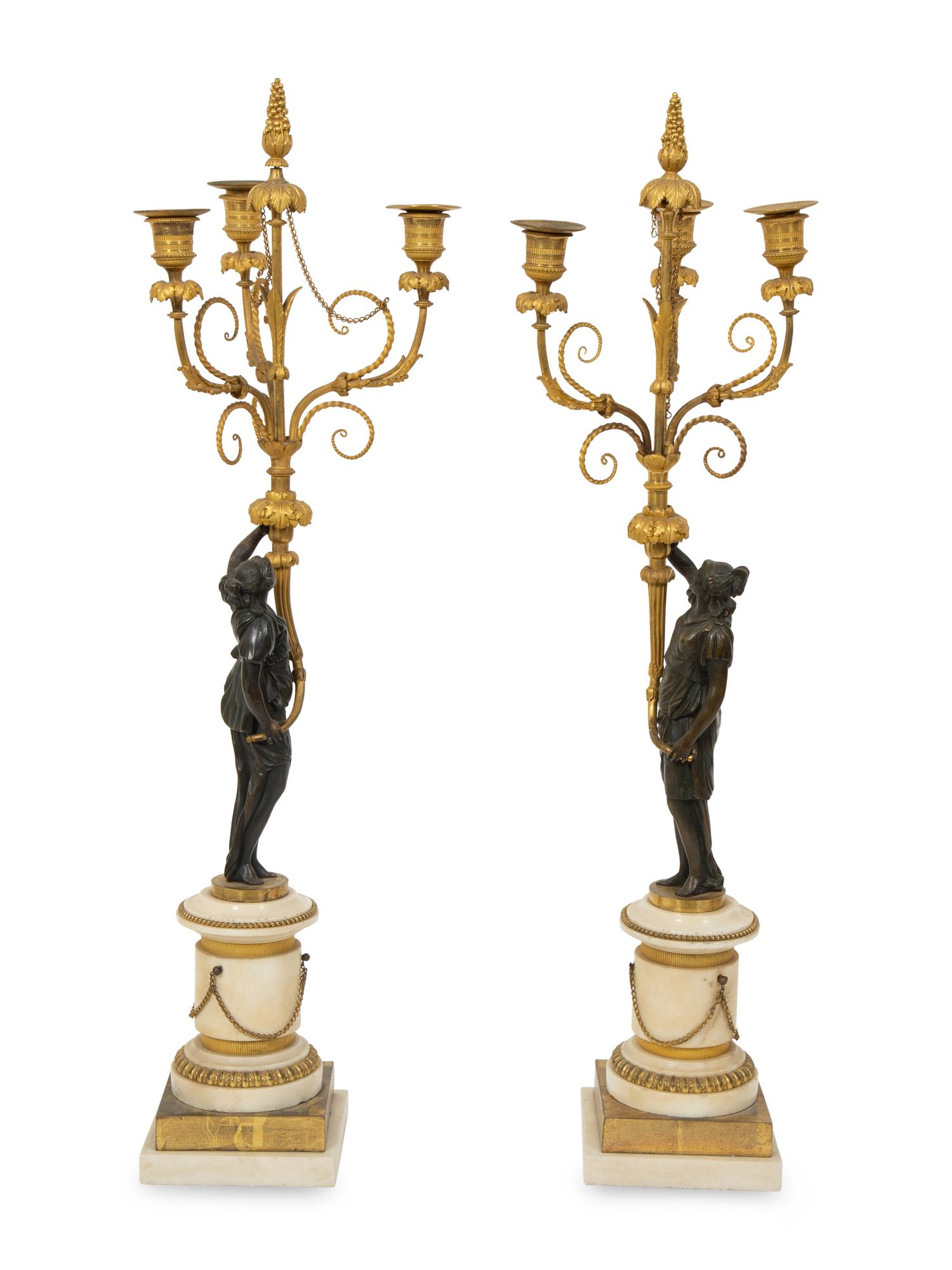 A Pair of French Patinated and Gilt Bronze Figural Three-Light Candelabra