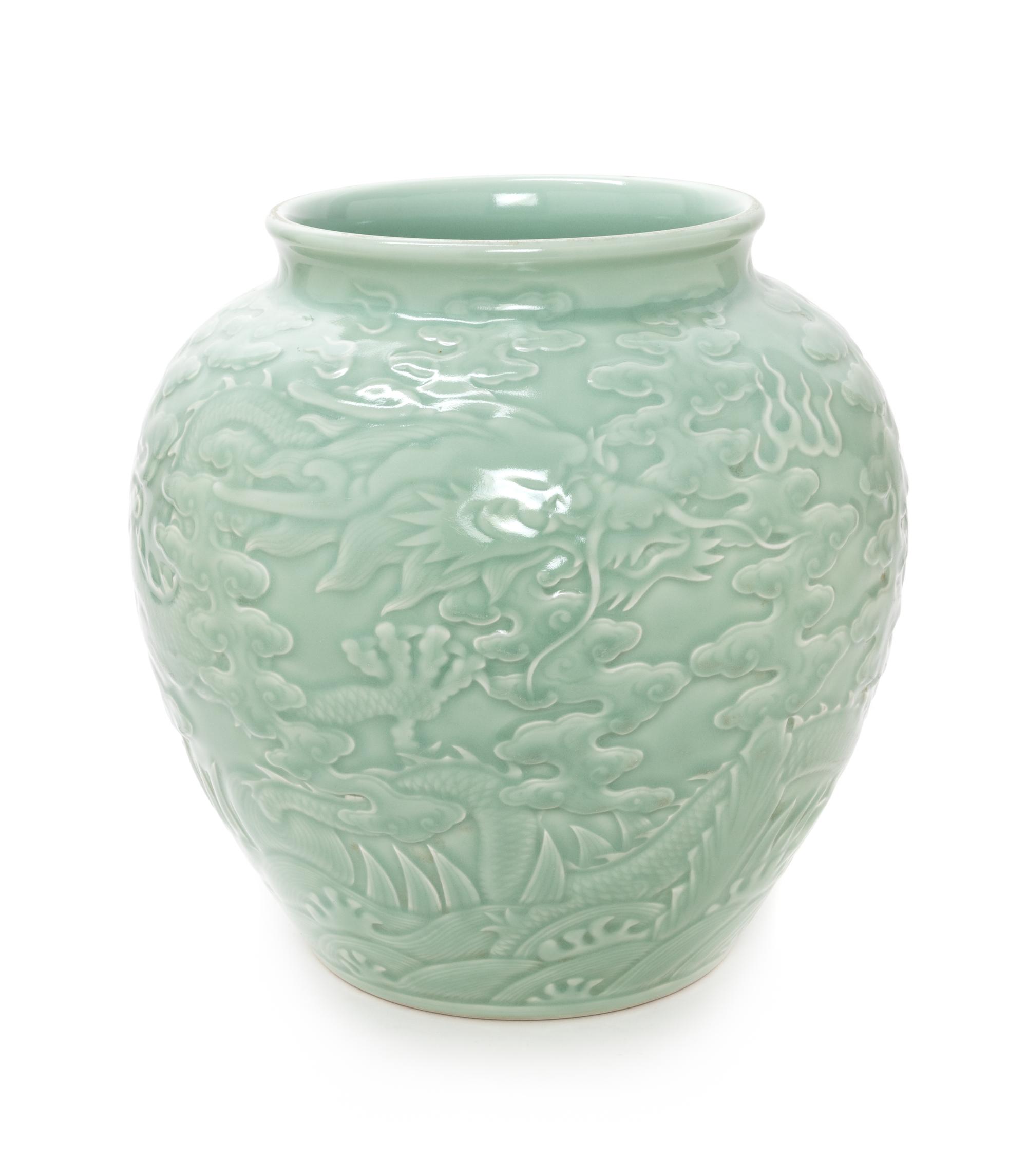 A Chinese Carved Celadon Glazed Porcelain Jar Height 12 1/2 inches. — 20TH CENTURY