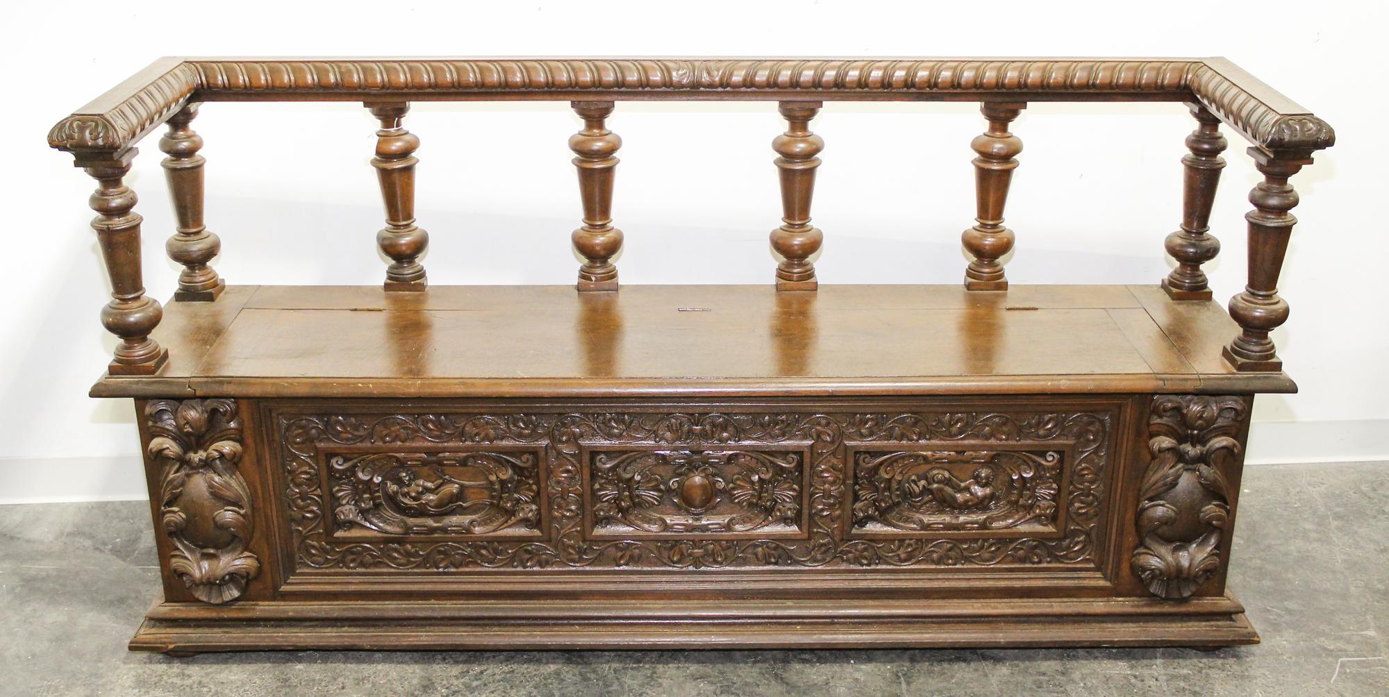 A Continental Carved Walnut Hall Bench. Width 74 inches.