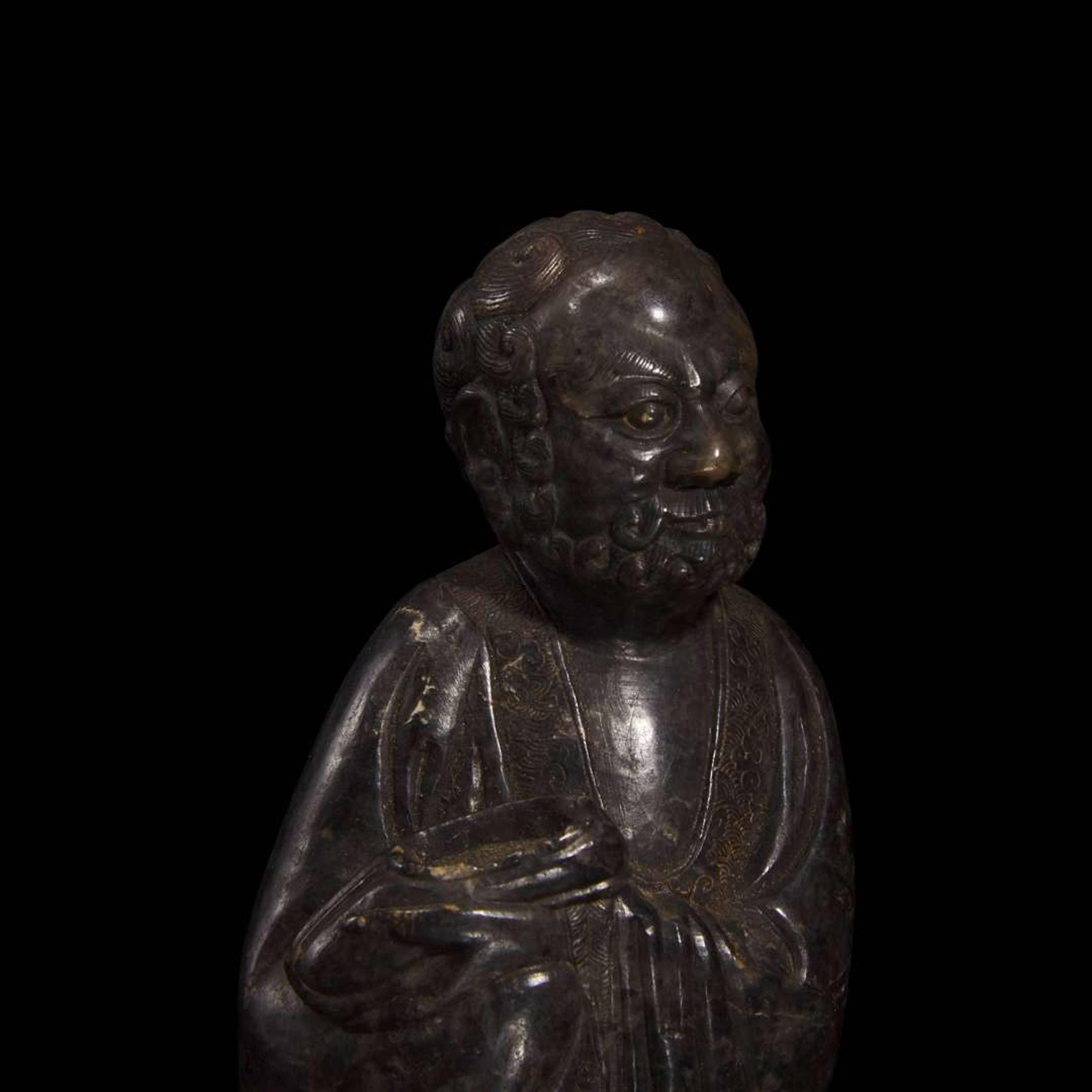 A Chinese carved dark soapstone Luohan 寿山石雕罗汉