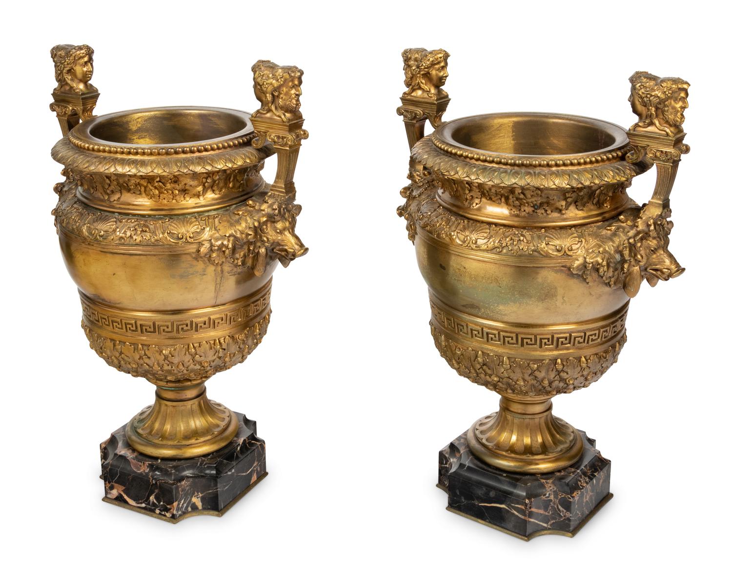 A Pair of Neoclassical Gilt Bronze Urns on Marble Plinths