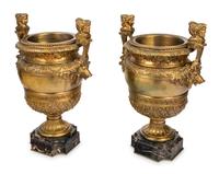 A Pair of Neoclassical Gilt Bronze Urns on Marble Plinths