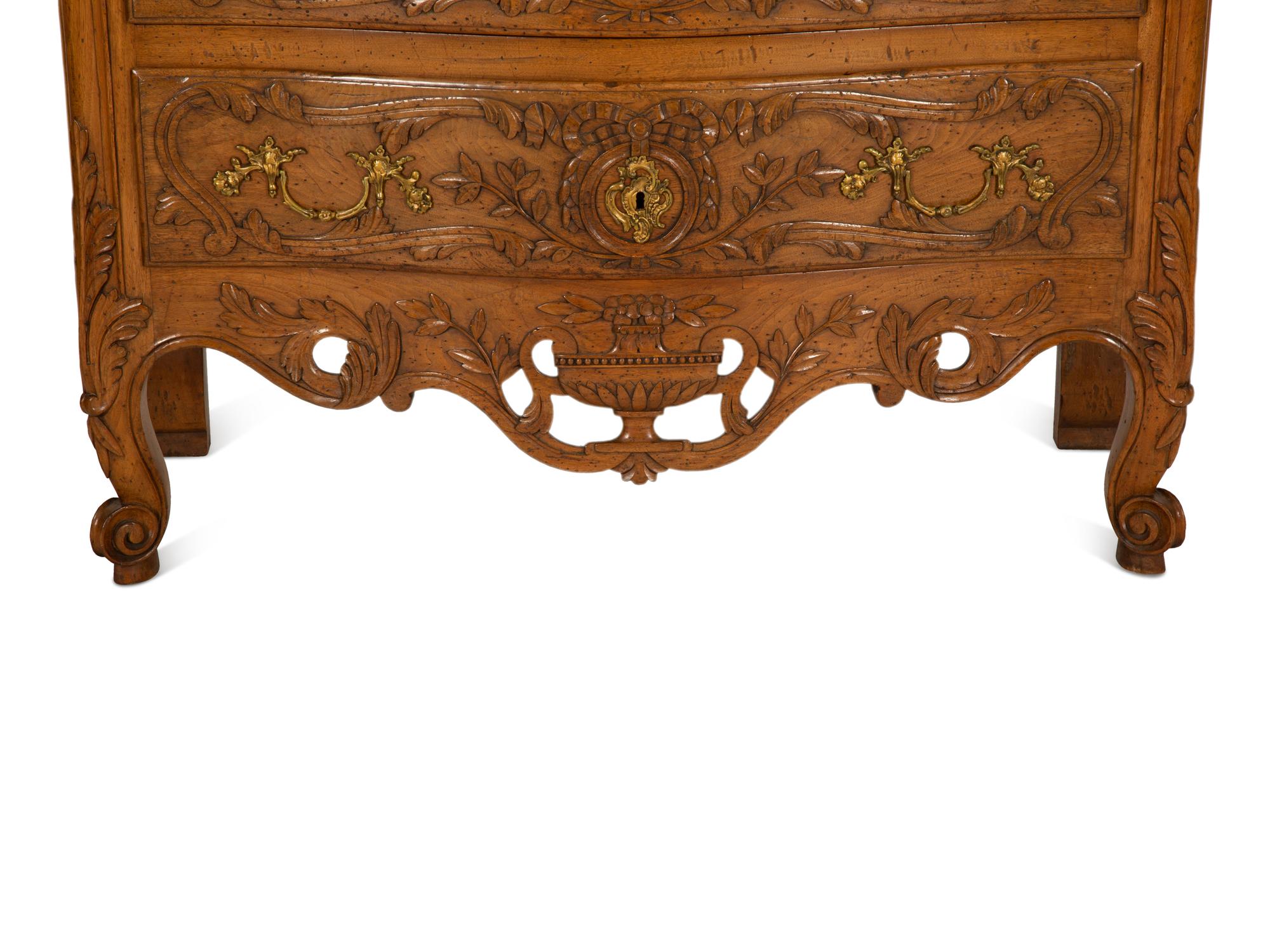 A French Provincial Carved Oak Commode
